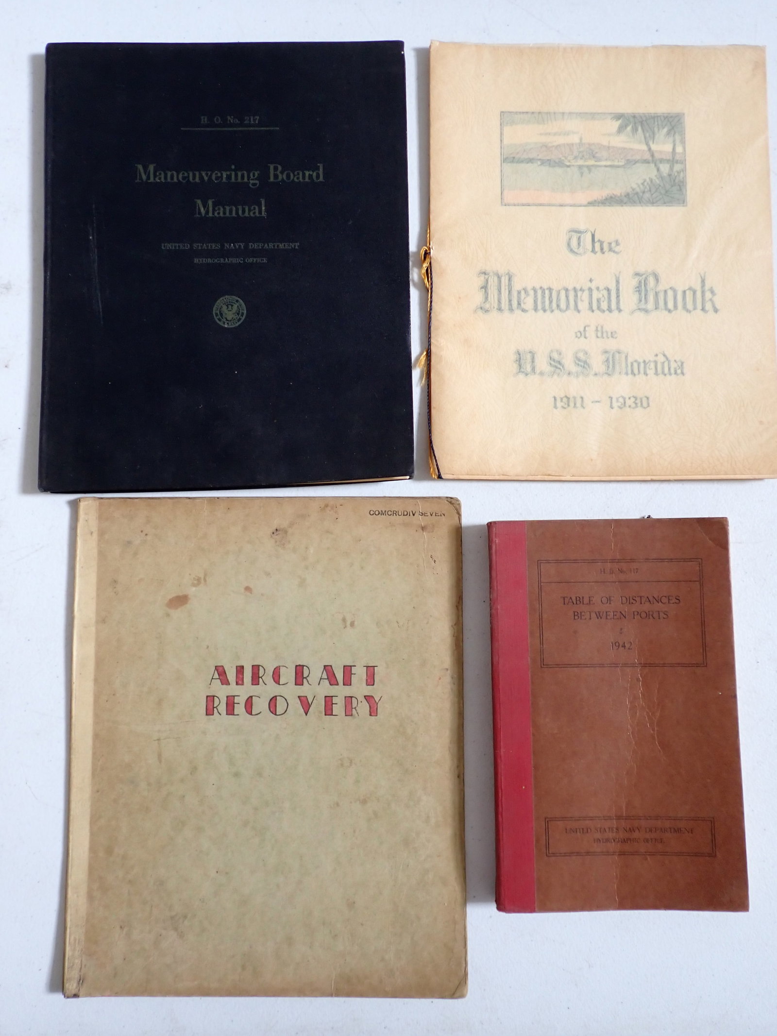 Aircraft Recovery Confidential Letter, Navy Maneuvering Board Manual, etc.: World War II era Aircraft Recover Letters in Folder. 1941 Navy Maneuvering Board Manual. The Memorial Book of the U.S.S. Florida 1911-1930. U.S. Navy Table of Distances between Ports. Show some wear.