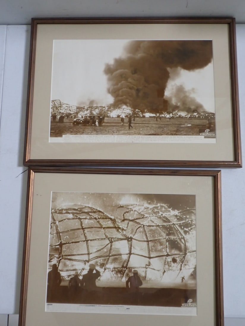 2 Framed Hindenburg Disaster AP Wire Photos: Photo shows men in foreground. One appears to be in uniform saluting as the zeppelin burns to the ground. There is another figure in the right corner much closer to the fire. The caption describes the