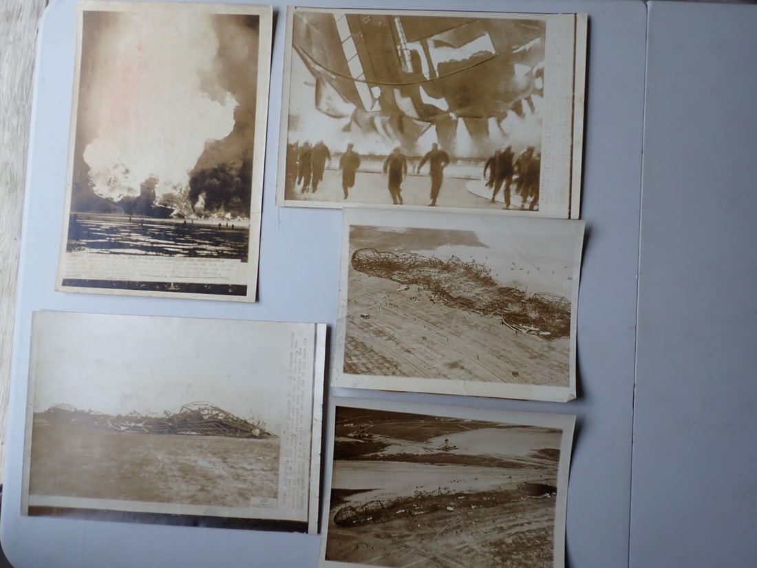 5 Photos of the Hindenburg Disaster: 3: 8" x 11 3/4" Photos: One shows 7 Ground Crew Members Running to Escape the Flames as the Hindenburg Burns. Another shows the dirigible burning on the grounds. The last shows the aftermath with the 