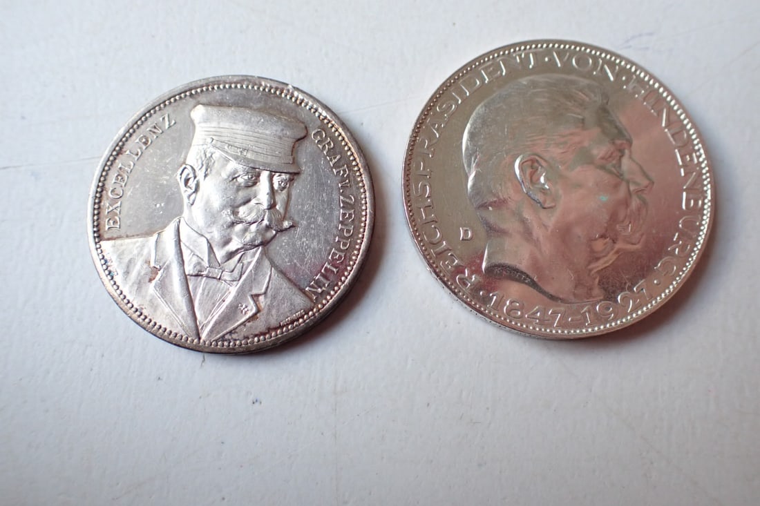 1908 Silver Proof of Zeppelin over Strasbourg & Hugo Echner Medals: Handwritten label describes it as 1908 34 mm Silver for the Strousbourg Flight LZ4 Reverse. Count Zeppelin in Cap on Obverse. .99 silver. Also, 1929 Hugo Eichner Zeppelin Medal.