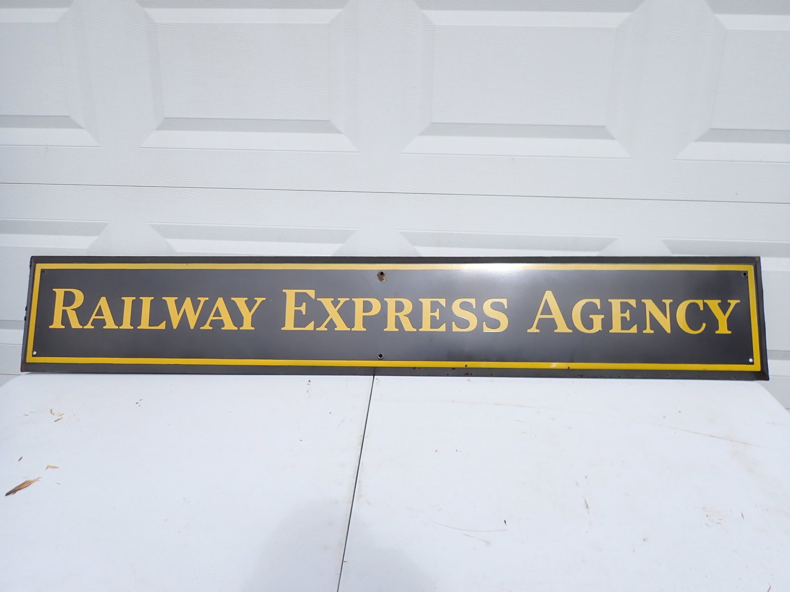 Railway Express Agency Enamel on Metal Sign: Has a chip by hole at top and minor chipping along edge. Reverse has some surface rust but good overall condition. 6' x 1'