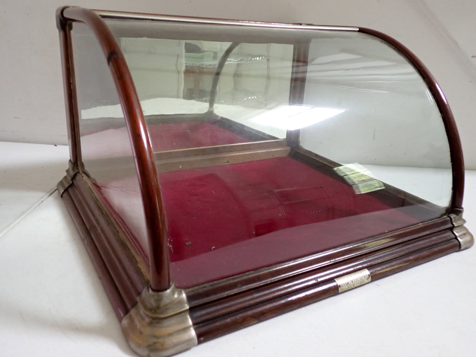 Country Store Farley & Hofman Countertop Display Case: Farley & Hofman 39 & 41 West Bd’way New York Label. 18 ½” Wide. 10 ½” High. 15 ½” Deep. Curved Glass and Felt Lining. Mirrored back. Has some wear with a split