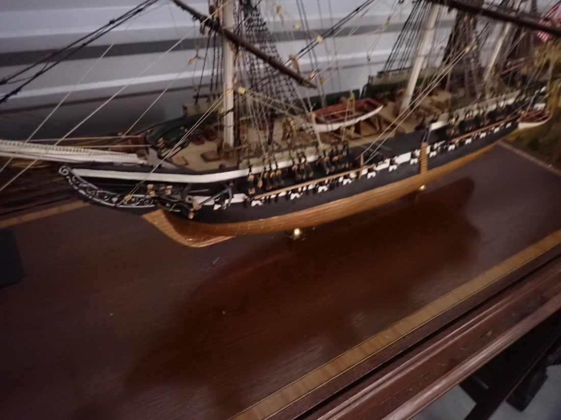 USS Constitution Lannan Ship Model, Boston in glass case: Made by Lannan Model Ship Galleries, Boston, MA. Ship appx. 40" long and glass case with inlaid design border 30" high x 45" long 18" deep. Base is 31" high. In great condition.