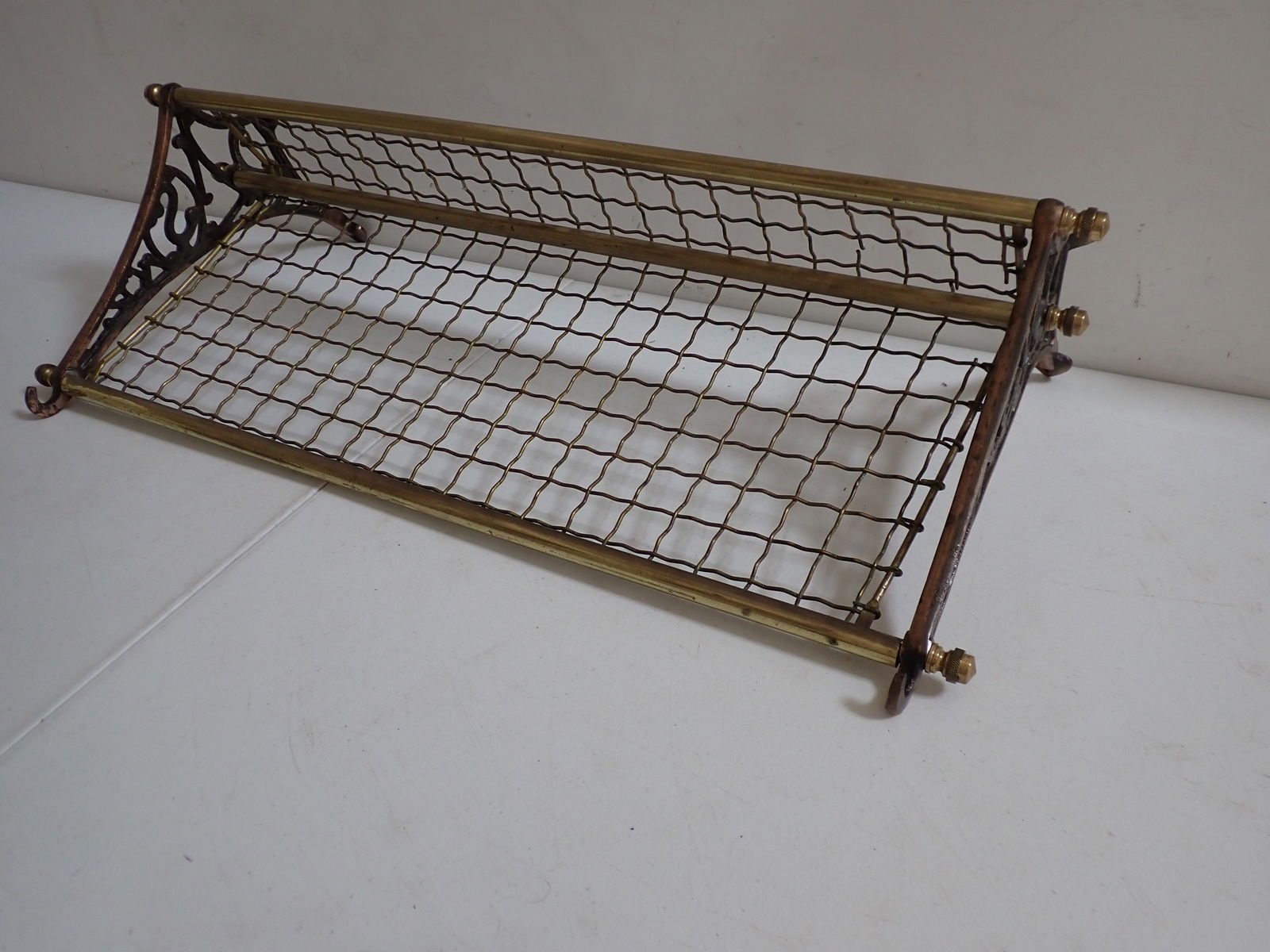 Antique hat / clothing rack: Copper and Brass with wire frame design. Wire has some broken pieces, but overall good condition. 30" wide. 14" bracket.