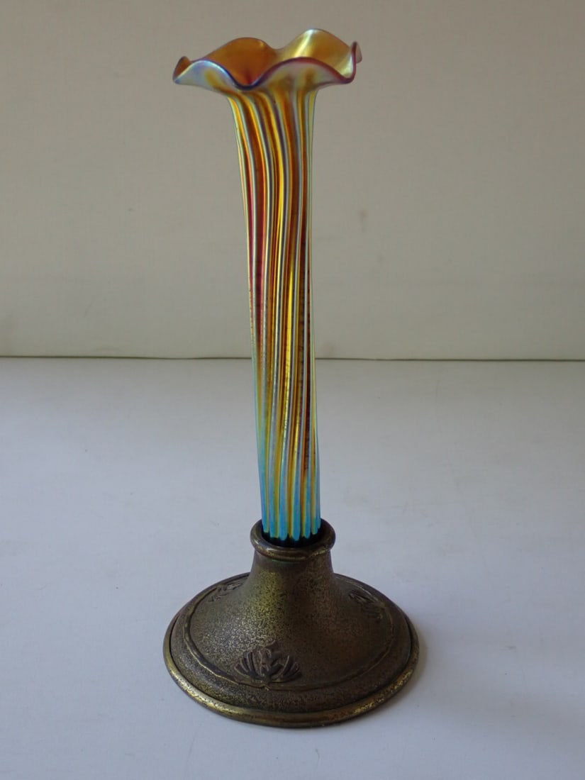 Silvercrest Art Glass Vase: iridescent gold glass with ribbed body and ruffled rim held in a Silvercrest gold patinated metal base. Glass unmarked; attributed to Steuben. Silvercrest base marked. 3 7/8" diameter x 9" high. No cr