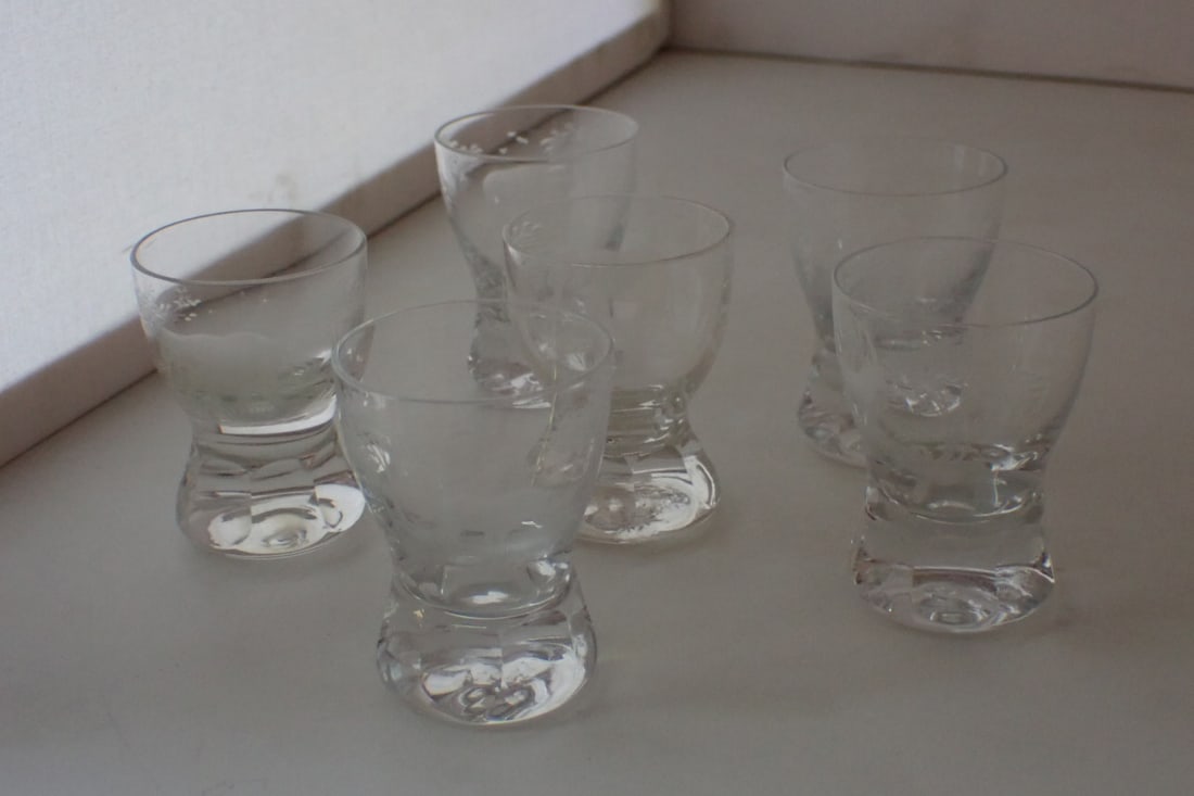 Set of Six Moser Rowland Ward Safari Cordial Glasses: each clear glass with engraved animal. gazelle, water buffalo, giraffe, two elephant, rhinoceros. Unmarked. 1 7/8" diameter x 2 5/8" high. No cracks or chips except as noted. Light wear from use. Wate