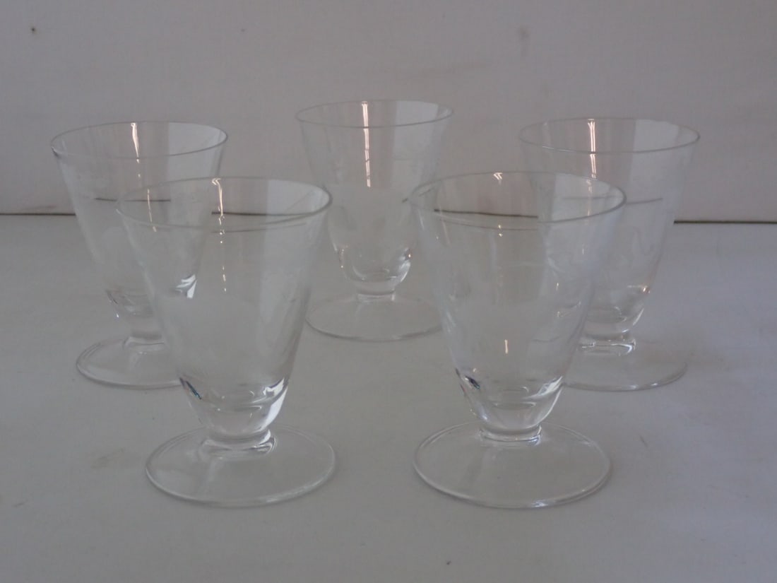 Set of Five Moser Rowland Ward Safari Cordial Glasses: each clear glass with engraved animal. Lion, gazelle, water buffalo, elephant, rhinoceros. Unmarked. 2 1/4" diameter x 3 1/8" high. No cracks or chips. Light wear from use.