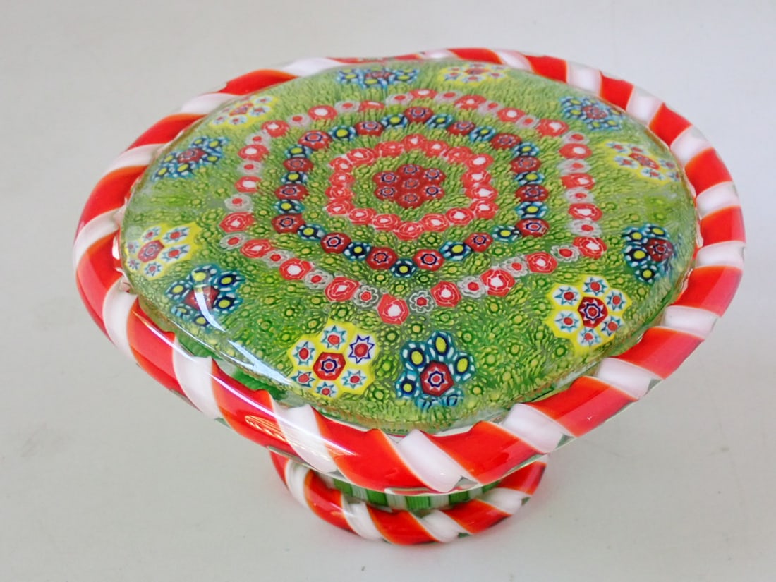 Large Glass Paperweight: heart-shaped top with millefiori canes set in a close concentric pattern surrounded by a red & white twisted barber pole cane. The base with green and white basket stave canes. Unmarked. 7" wide x 7"