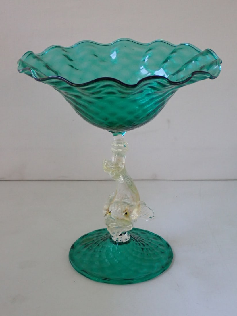 AVEM Murano Glass Compote: blue-green glass top and foot supported by a dolphin-form gold-flecked clear glass post. AVEM paper label. 7 3/8" diameter x 8 3/8" high. No cracks or chips.