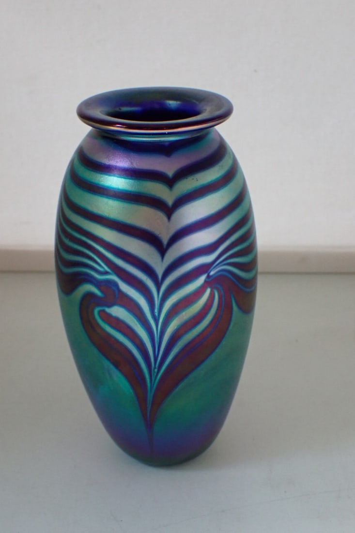 Art Glass Vase: iridescent blue glass with pulled feather design, marked Eichs, 1985, attributed to Robert Eickholt. 3 1/4" diameter x 5 3/4" high. No cracks or chips. Wear from use. Ground base.