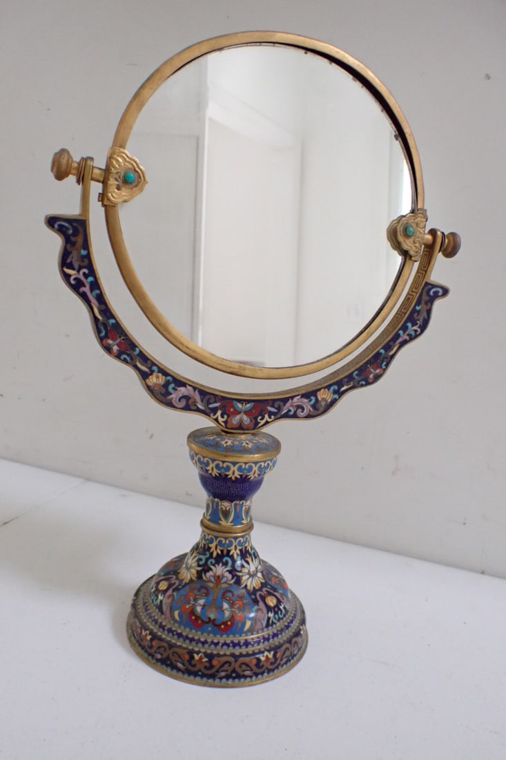 15" Vanity Mirror Cloisonné: 15" height, mirror 8" diameter Cloisonne mirror with floral design and butterflies, brass edging, brass mirror, paper label, mirror is loose in frame, otherwise good condition