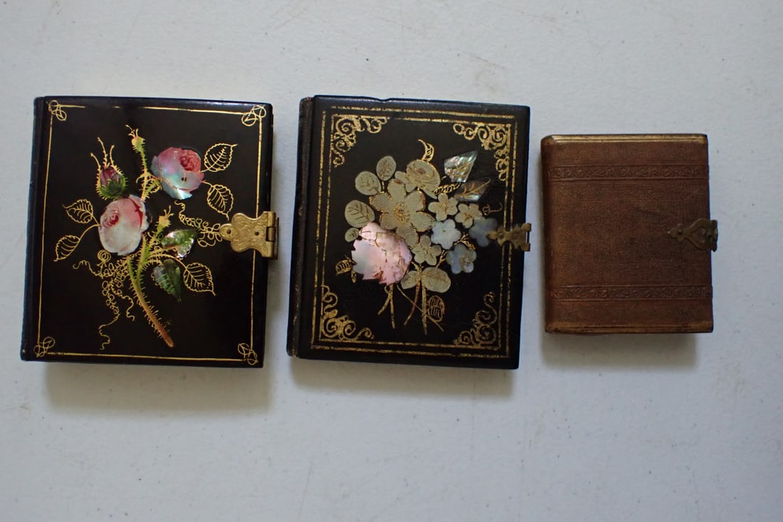 Mother of Pearl Cases with Early Photographs: Rose Design Mother of Pearl Lacquer and Gold Leaf Frame with Ambrotype of Man and Woman inside. Floral Felt Design inside and Clasp Marked Bijou. 4" x 3 3/4", Inlaid Floral Design with Tin Type of Man