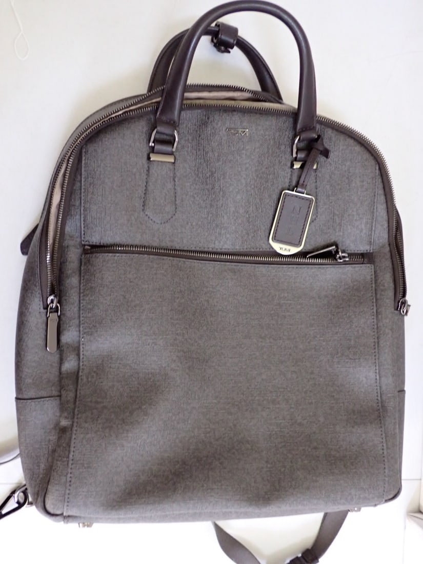 Tumi gray PVC Backpack: TUMI PVC backpack with multiple zipper compartment inside including a velvet lined jewelry section Width 12" Height 15" . Some stains inside