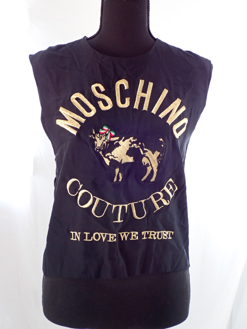 Moschino Couture Womens Sleeveless tunic shirt Size 10: Embroidered and appliqued cow. Black material with gold embroidery Size 10. Height to top of Mannequin is 68".