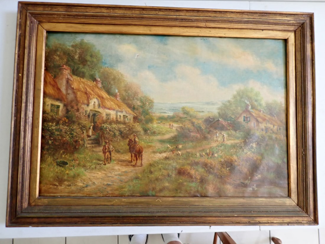 British Countryside Oil on Canvas Signed J.J. Hughes: Country Village with Thatched Roof House & Water View in Background. Has some paint loss and tear. Painting was removed from the frame to prevent damage. Frame 25 1/2" x 35 1/2" Art 20" x 30"