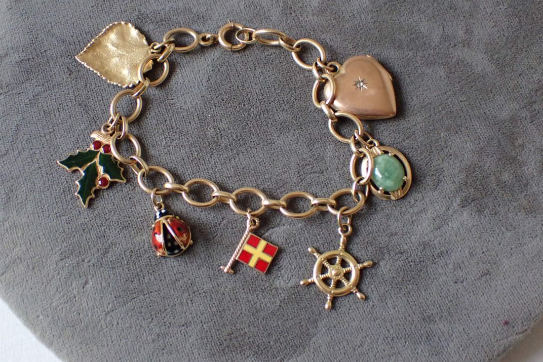 14K Charm Bracelet and Charms: Measures 7 1/2". Total Weight 23.9 Grams
