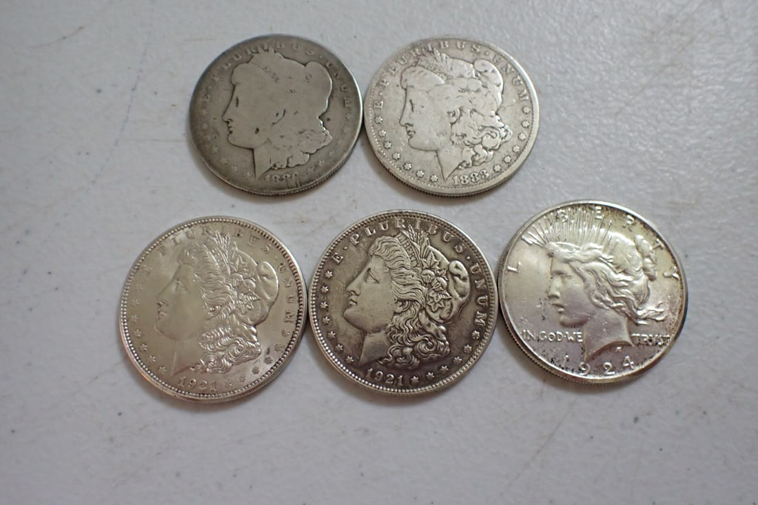 4 Morgan Silver Dollars and a Peace Dollar: 1880-S, 1883, 1921, and 1921-D morgan Dollars and 1924-S Peace Dollars.