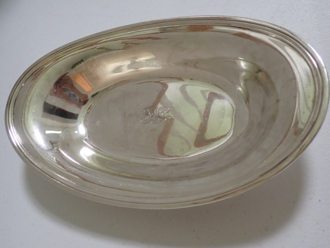 Tiffany & Co. 10 1/2" Sterling Bowl: Marked Tiffany & Co. Makers. Sterling Silver 22551. 10 1/2" x 6 1/2". Monogrammed. Some minor scratching and small dent. Overall good condition. 11.8 Troy Ounces