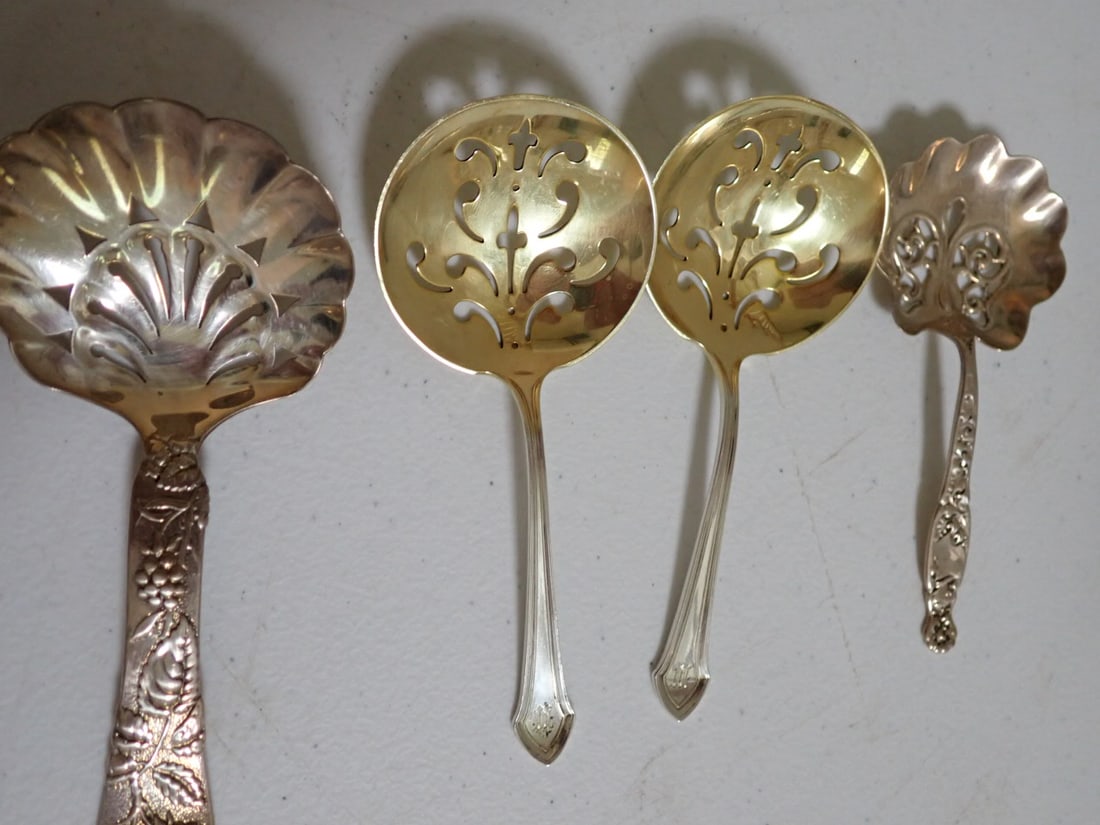 1 Tiffany, 2 gold wash, and other bonbon spoons (4 pieces): (1) Tiffany is 5", (2) gold wash spoons are 4 3/4" monogrammed, (1) bonbon spoons 4 1/2". 3.1 Troy ounces.