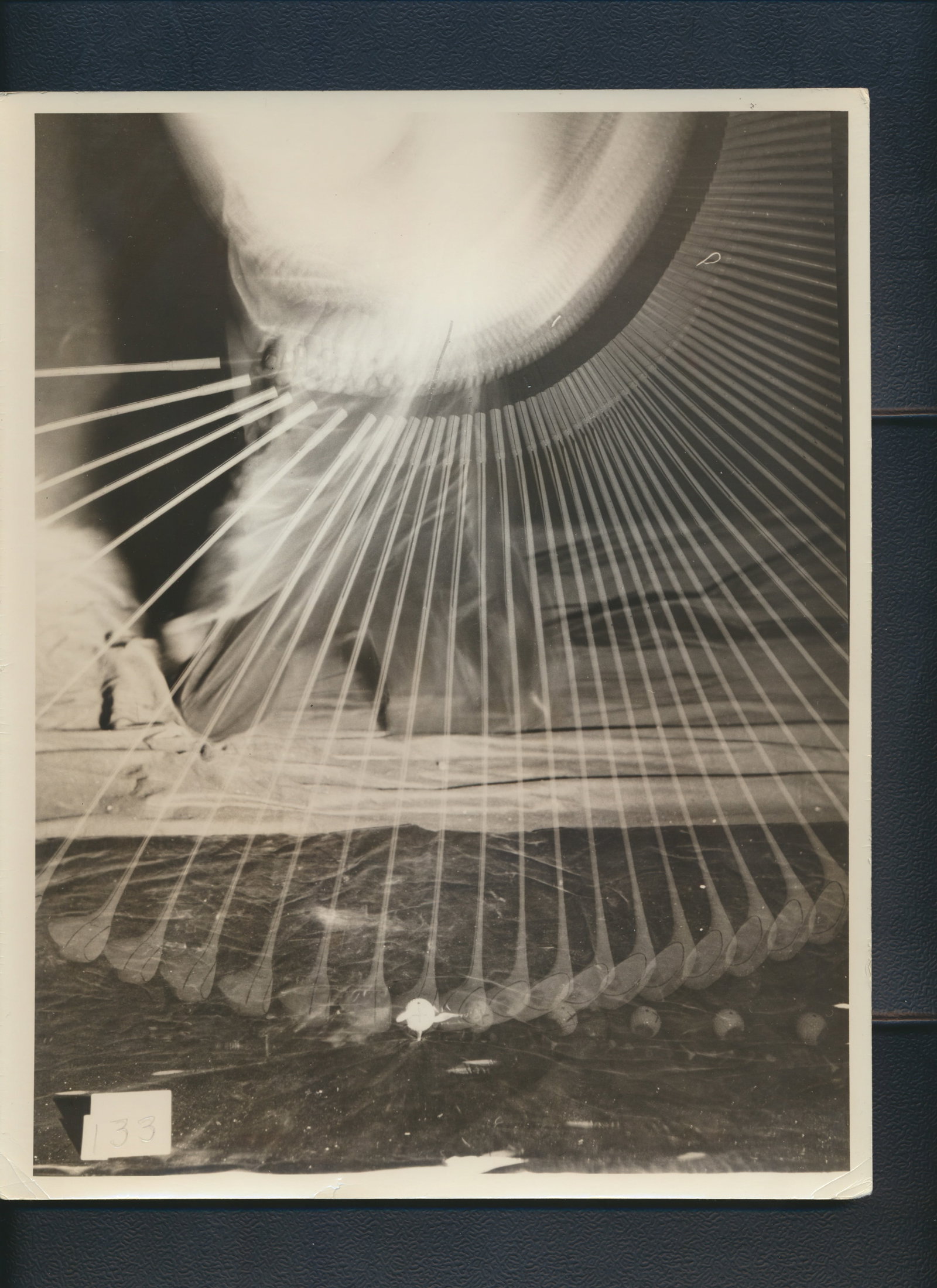 Spalding R & D Tru-Face Golf Club Photos & Calculations: 4 Silver Gelatin Photos showing gold swings used by Spalding Research and Development Department. First 8" x 10" Has # 133 label in photo next to club. Marked in pencil on reverse is "105.2 D = V" "5 