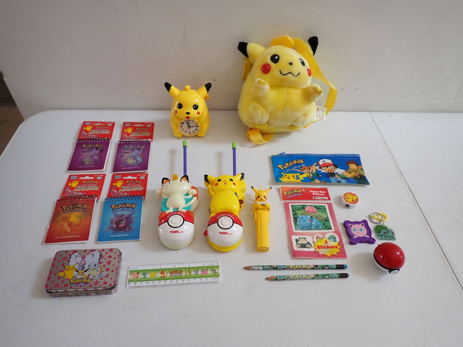 Pokemon Alarm Clock, Walkie Talkie & Other Items: Pokemon Quartz Alarm Clock 1990's, Pokemon Walkie Talkie, Tiger 1999 with Pikachu and Meowth - Works (Batteries not included), Pikachu Backpack, some wear, 4 Unused Mini Notebooks, Pez Dispenser, Tin,