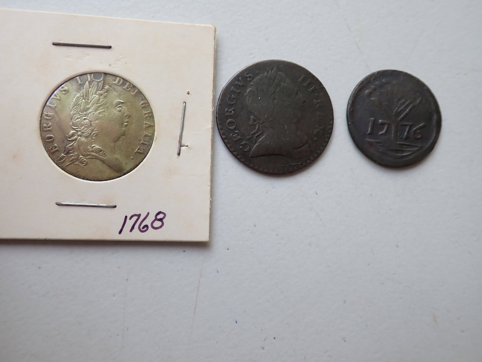 1775 George Half Penny & Tokens: Half Penny and commemorative coins. Pine Tree Penny (marked Copy) and coin marked in memory of the good old days. Coin holders may show grades but have not been graded by us. Please view photos to see