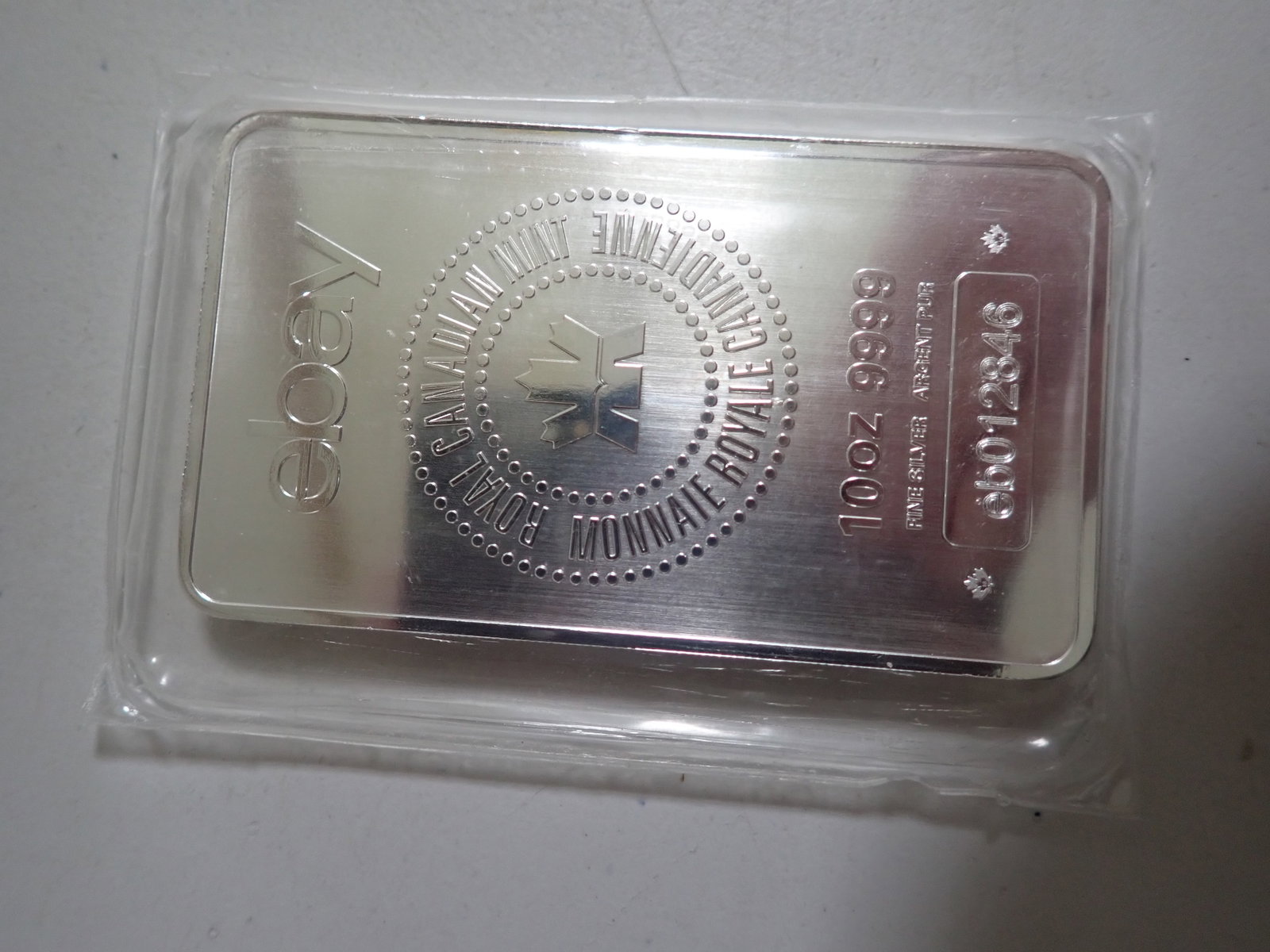 10 oz Royal Canadian Mint .999 Silver Bar eBay s/n eb012846: Encased in plastic.