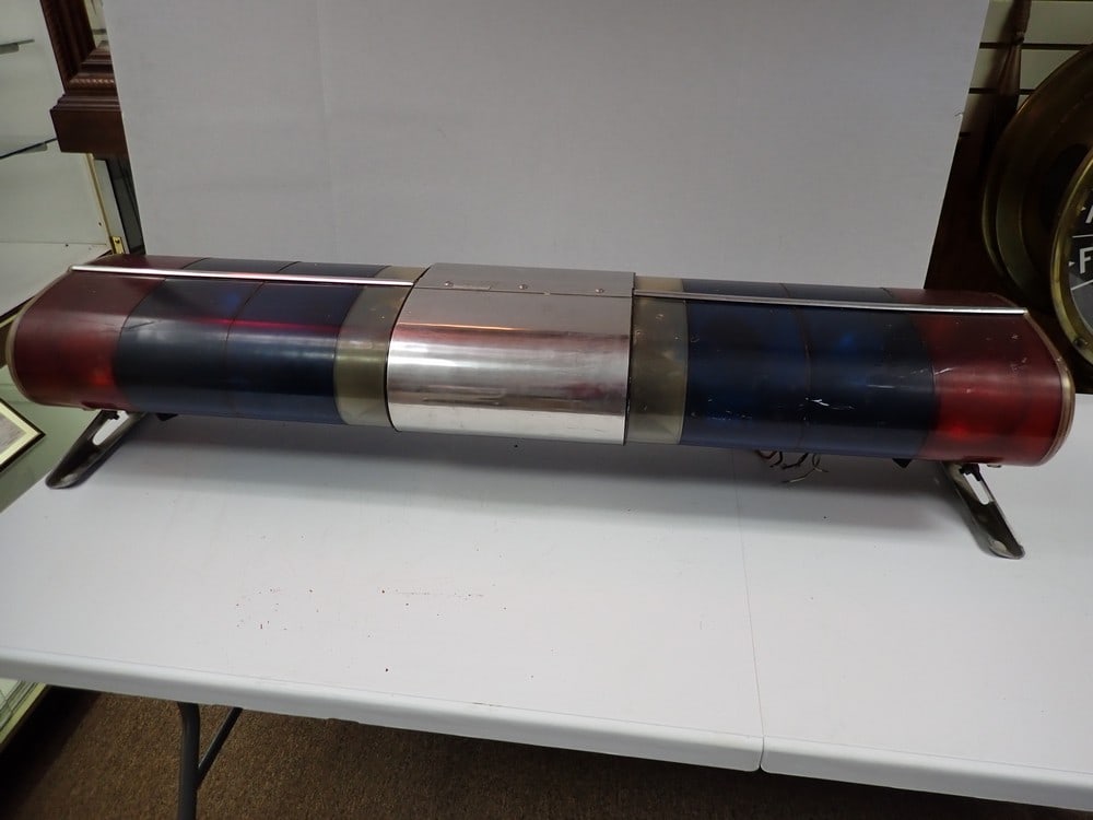 "City of Ravena" Police Car Roof Lights: Blue, Red and White Roof Light Rack. Marked "City of Ravena" on Chrome on top. Plastic case shows wear and scuffing 47" x 9" H