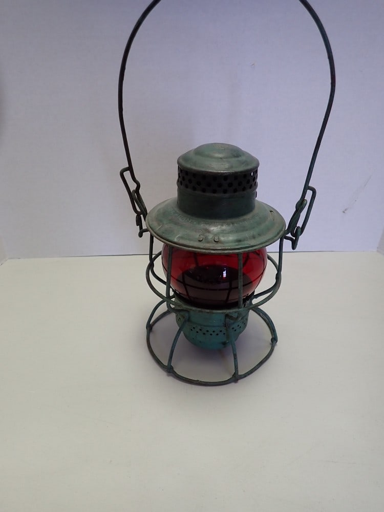 "Adams and Westlake P.R.R." Red Globe lantern: Marked "Adams and Westlake P.R.R.". "P.R.R." logo on top lanterns and globe. Patent ending 1923 USA Canada. Painted green, base bent