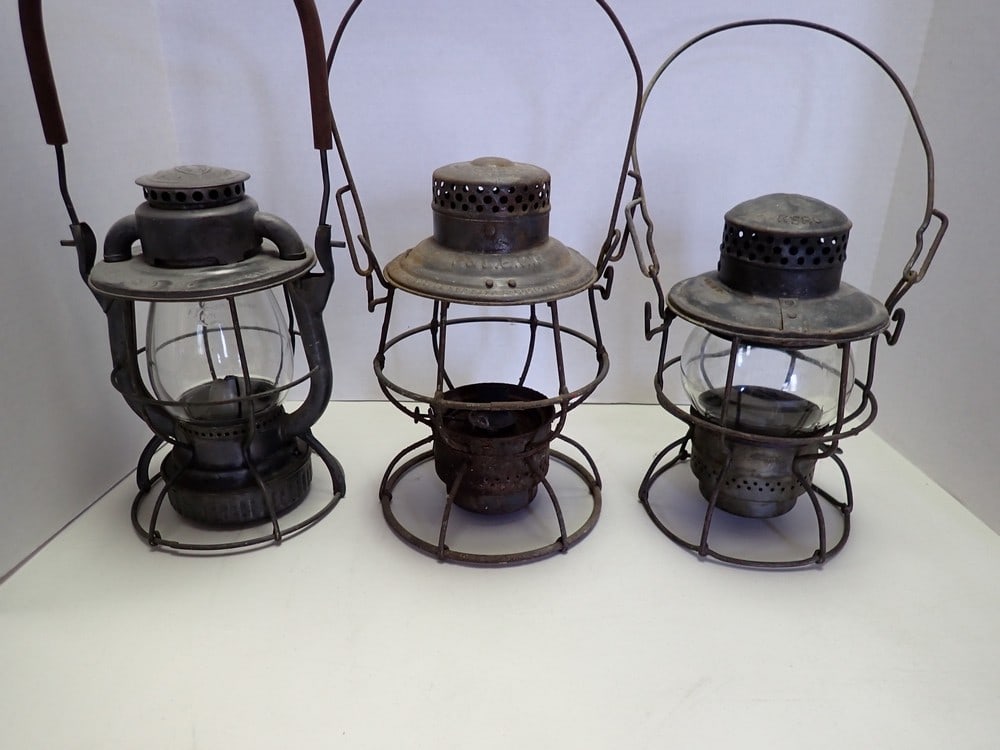 3 Pennsylvania Area Railroad Lanterns: "Dietz B & L.E. R. R." Stands for Bessemer and Lake Erie R.R." Has rubber. "L.V.R.R." Stands for Lehigh Valley, light wear on top. "Adlake" "P & L.E. R.R." Pennsylvania and Lake Erie R.R., has rust an