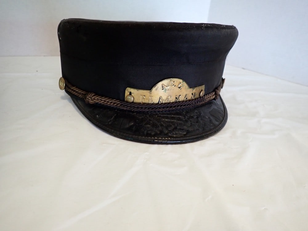 "ACL" Flagman Cap. (Atlantic Coast Line): Shows some wear, marked A.C.L. Brass Buttons, Brass Plate is marked "A.C.L. Flagman", some tearing & warping of visor.