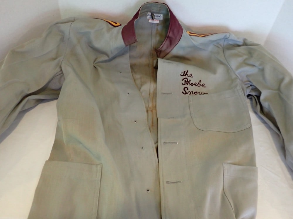 "Delaware, Lackawanna, & Western Phoebe Snow" Coat: Trainman Coat is embroidered with "the Phoebe Snow," has epaulets on sleeves & matching colored cuffs. Has some fading, staining & is missing buttons, Size 40.