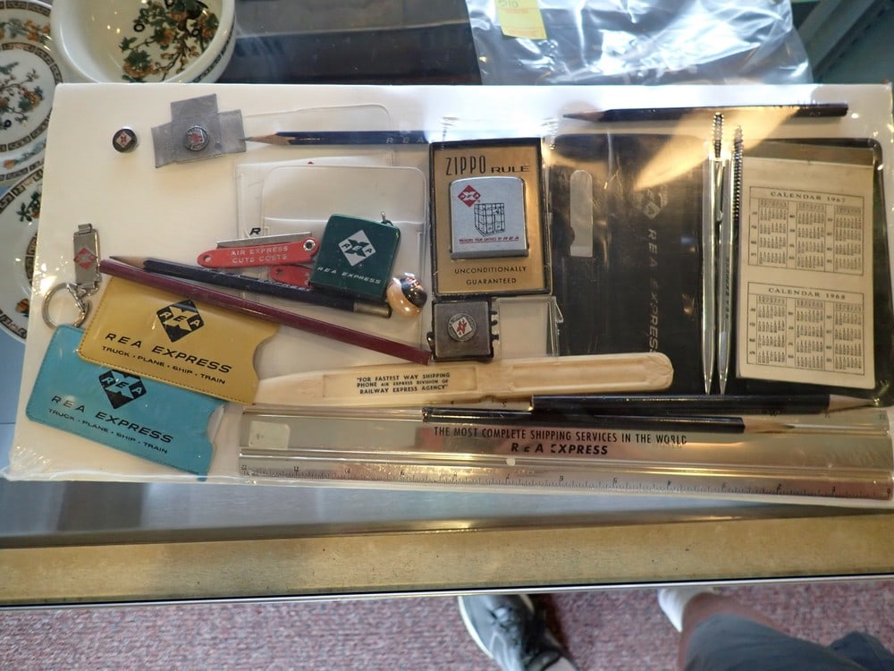 Railway Express Agency Promotional Items: Zippo lighter, Tape measure, Ruler, Pins, etc. shrink wrapped on board.