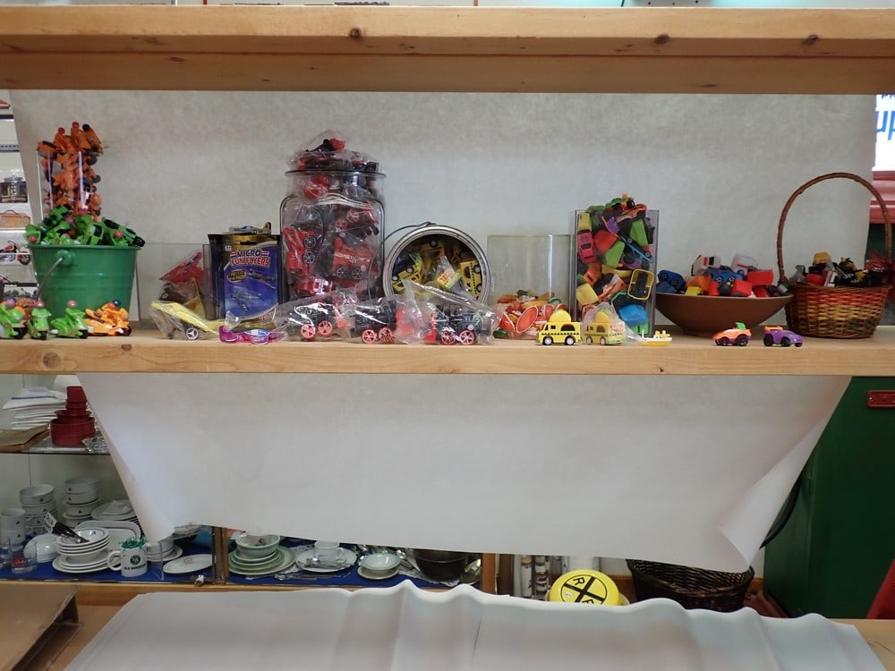 Large group of small transportation related toys: Plastic motorcycles, wind up train engines, boats, taco trucks etc. and micro foam flyers