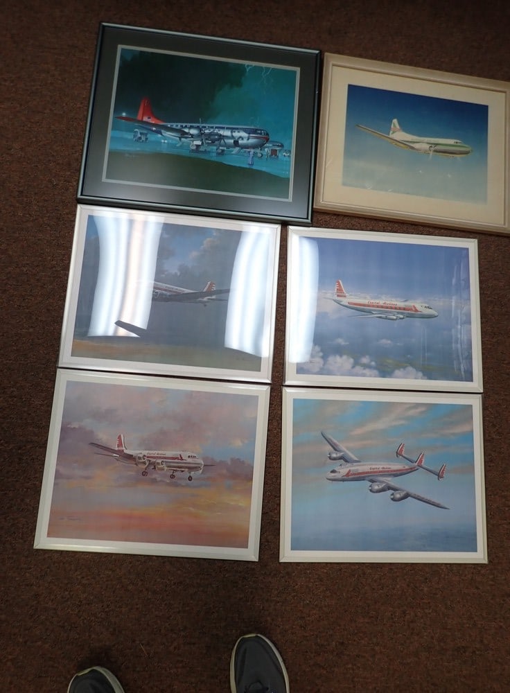 6 airplane prints: 2 wooden frames with glass. 4 plastic frames. Wood frames 19" x 23", glass and metal frame 17"x 21";plastic frames 16" x 20"