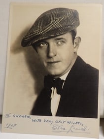 1928 Stan Laurel signed photo in cap w/bowtie