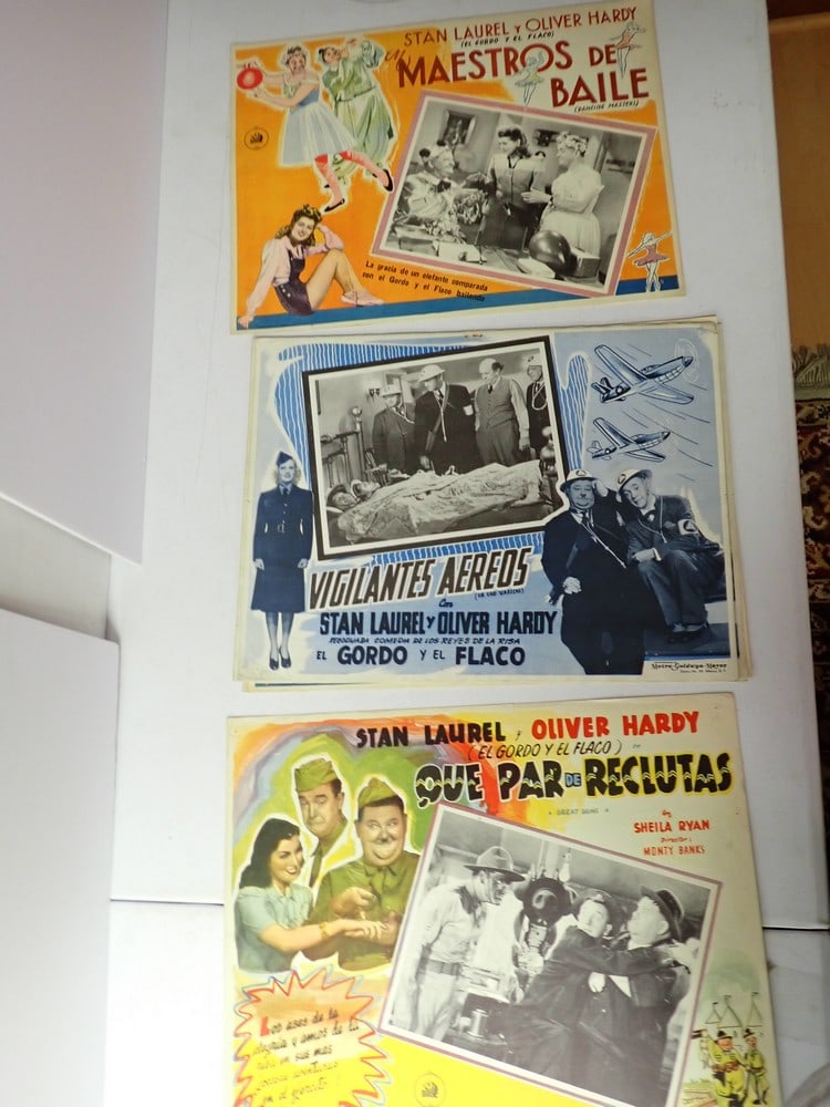 13 Laurel and Hardy Air Raid Wardens, Great Guns &: Dancing Masters Spanish Lobby Cards. Lobby cards are printed in Mexico. 4 Air Raid Wardens, 8 Dancing Masters and 1 Great Guns. 12 1/2" x 16 1/2". Several have pin holes. A little edge wear but most a
