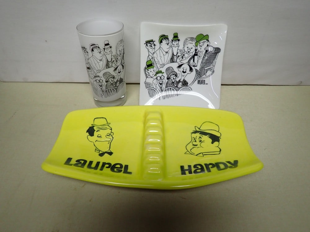 Laurel and Hardy Al Hirschfeld 1954 Movieland Glass: and Tray and Ken OCorr Ashtray. Tray or Trinket Dish is 5 3/4" x 5 3/4". The Glass is 5". The ashtray is 11" x 6 1/2" and is stamped Ken OCorr. The glass and tray are in very good condition. The ashtr