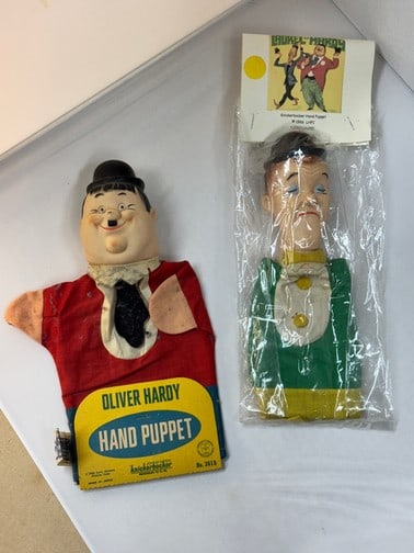 Knickerbocker Laurel and Hardy Hand Puppets: Hardy has cardboard packing that says 1966 Larry Harmon Pictures Corp. Made in Japan. Laurel has plastic packaging with cardboard that says Knickerbocker has puppet 1996. Hardy has some dust. Overall