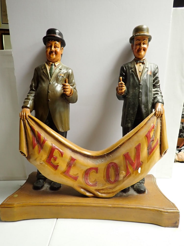 Laurel and Hardy Welcome Sign: Marked D. R. C. Resin Sign. Made in Philippines paper label. 23" with base 20". Small white paint drop on "M" in Welcome.