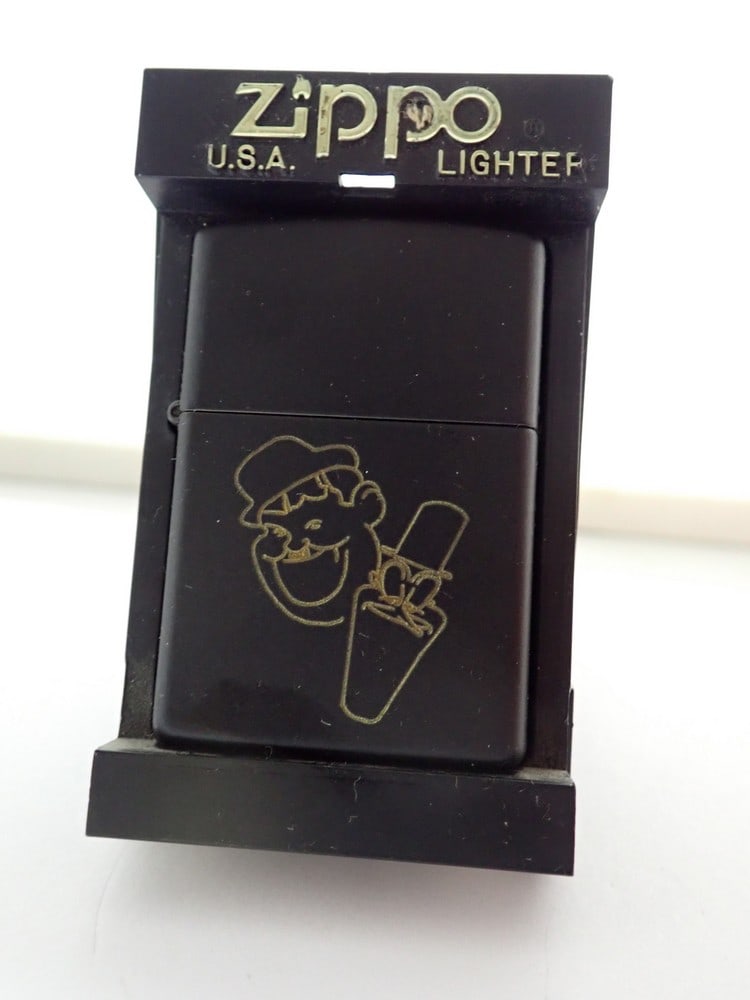 Matte Black Laurel and Hardy Zippo LIghter: Has cartoon images of Laurel and Hardy with Laurel and Hardy. Is unused and still has the original warning label on reverse. In plastic Zippo Case. Good unused condition.