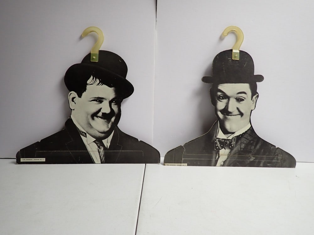 1967 Laurel and Hardy Henderson Hoggard Hangers: Henderson Hoggard Inc Figure Hangers. 16" x 16" Plastic on Hardy has some melting. Shows some wear with scratches and creases.