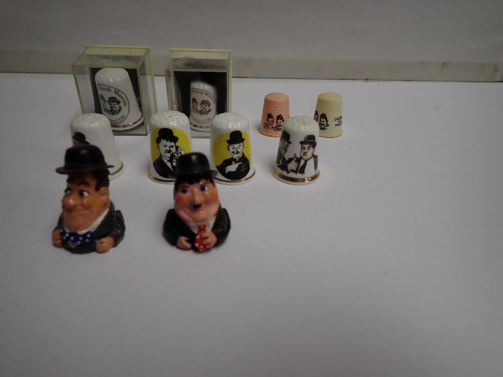 Laurel and Hardy Pewter, china and Plastic Thimbles: Stoke on Trent and Other fine bone china thimbles. Plastic, Metal etc. Last picture is another additional metal thimble set.