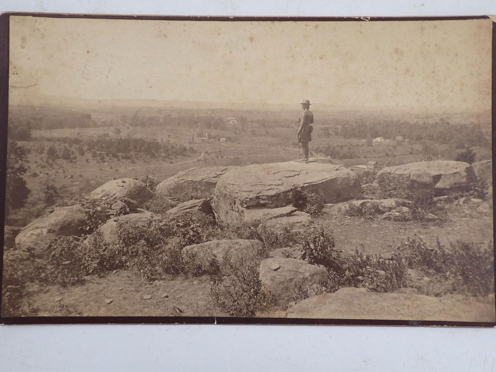 Photograph of Little Round Top, Gettysburg, PA: Photo pictures soldier monument on Little Round Top, Gettysburg, PA. Has some foxing, small tear and edge wear. 10" x 17"