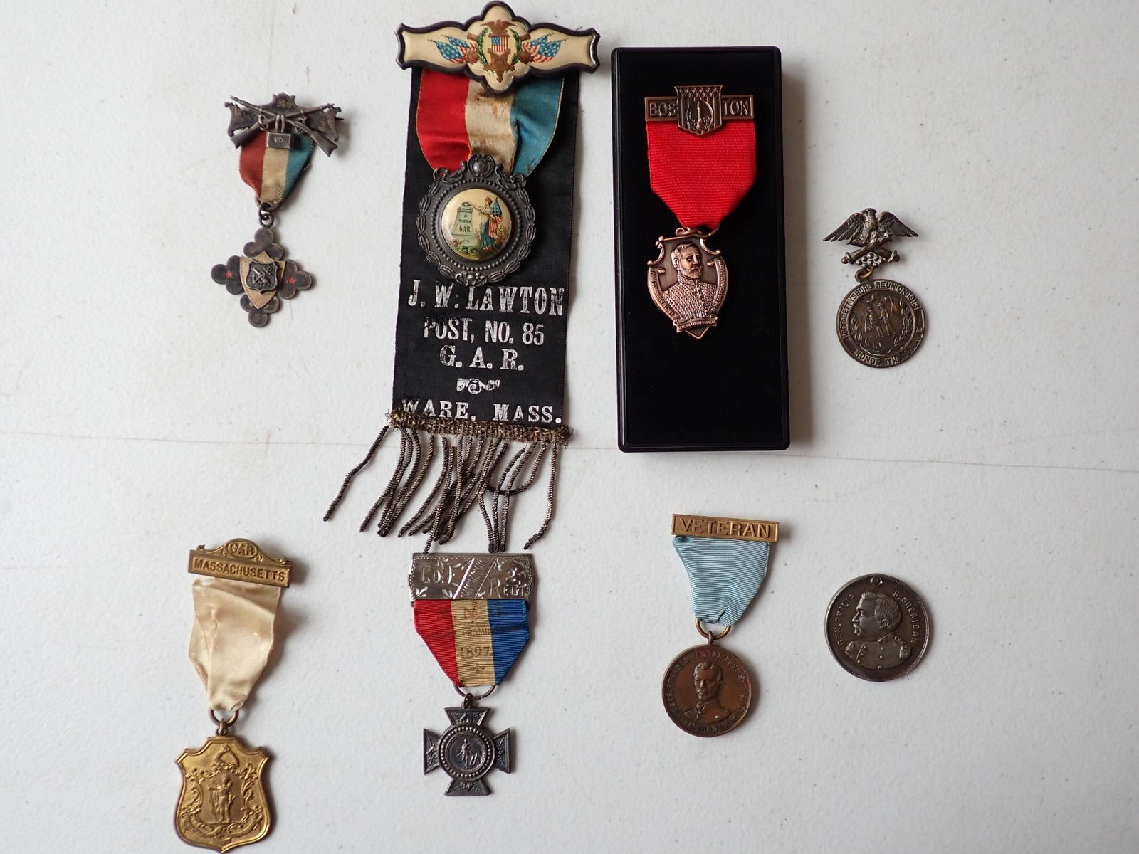 General Charles Devens & other medals: Anchor and crossed rifles medal. Label describes it as: "Sgt. Calvin A Weston, Grafton, MA. Gettysburg Reunion and other medals. One is just medal) not attached.