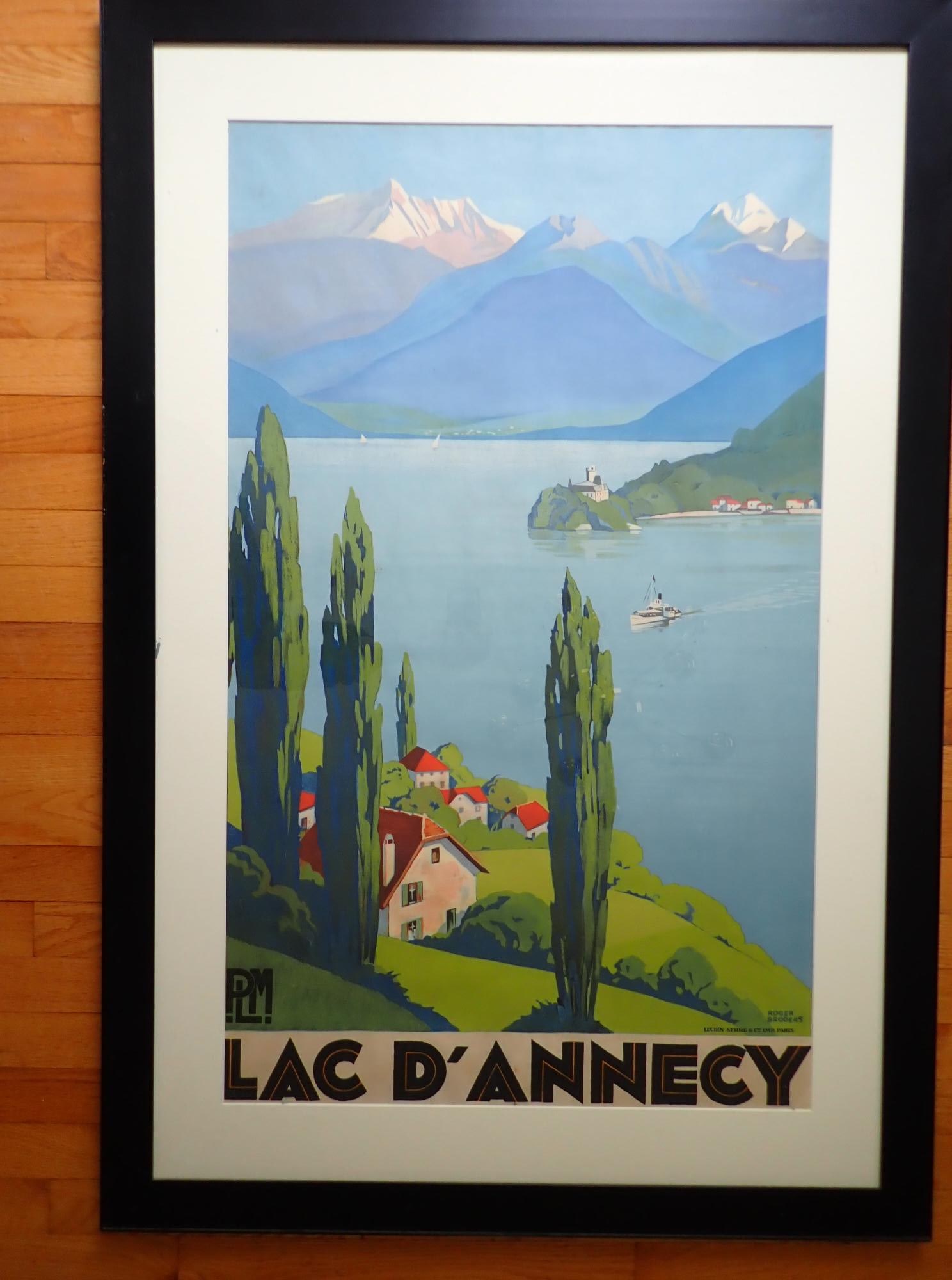 Lac D'Annecy France Travel Poster by Roger Broders: Poster 38" x 23" (excluding matte). Frame 48" x 33." Vintage Lac D'Annecy Art Deco Travel Poster by Roger Broders PLM Wall Art Deco. In the Haute Savoie region of France, Lake Annecy is only 50 kilome