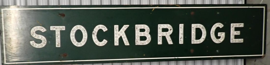 Stockbridge. MA road sign: Wooden sign with cats eye reflectors for Stockbridge, Massachusetts. 7' x 18". A few reflectors damaged but overall good condition.