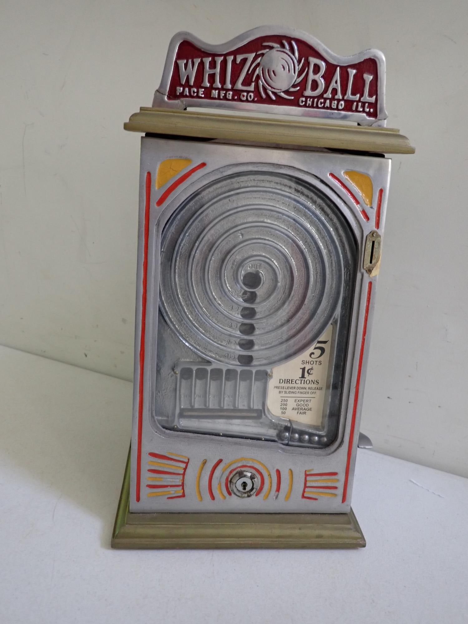 Pace Mfg. Whiz Ball Trade Stimulator: 5 shots for 1 cent. Lever to shoot balls works. No key for coin box. Whiz Ball metal sign has been repaired. 17" high x 9" wide x 7" deep.