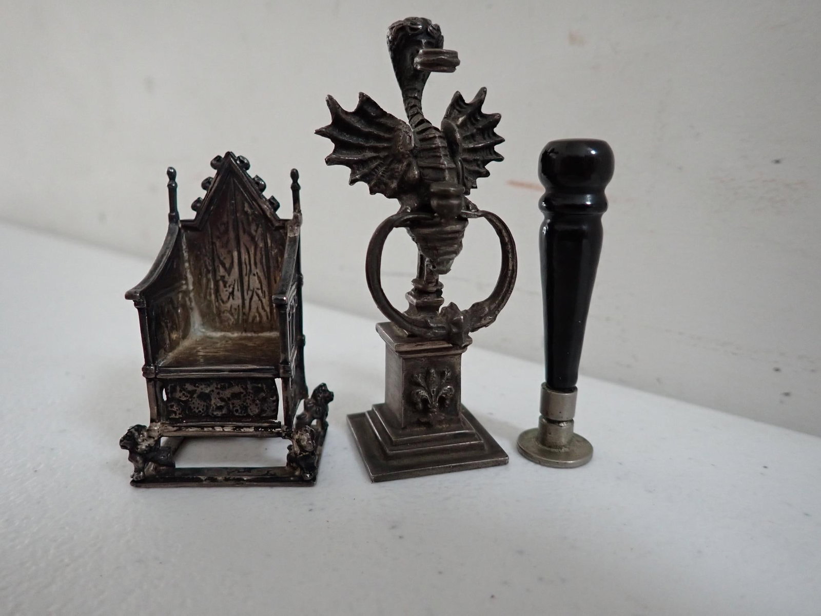 Silver Stamp and Miniature Chair: Stamp seal with winged dragon like figure. Marked .800 Silver. 3" high. A Silver Chair. Bottom is hallmarked CSES with lion and other British Hallmarks. 2" high. A metal and wood 2 1/4" stamp seal.