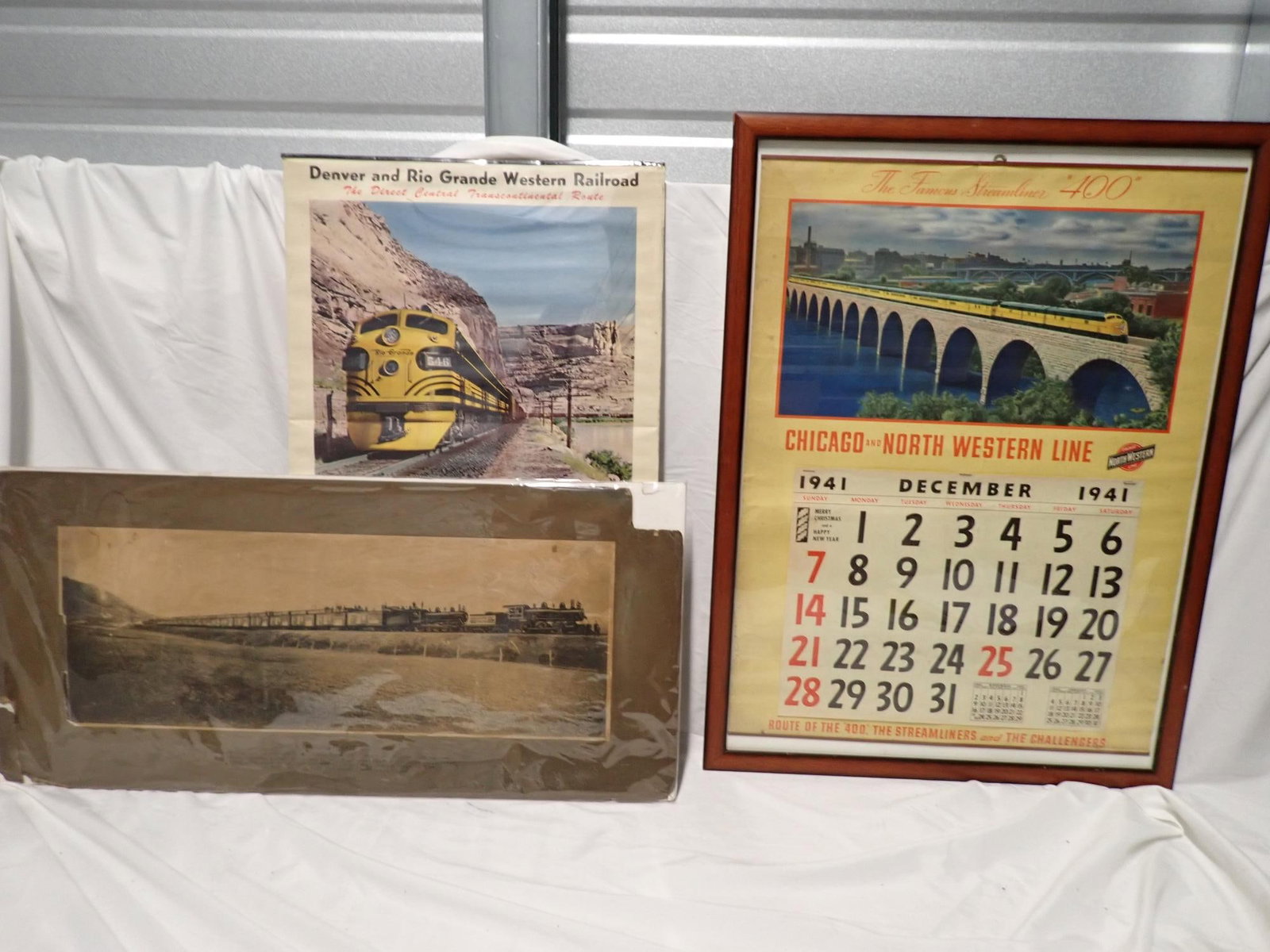 Worcester Salt Train Print and Calendars: Worcester Salt Specials Print 13" x 28". Corners Chipped and has staining. 1941 Chicago and North Western Line Framed Calendar - Parital Pad (December). Frame 27" x 20". Edge wear and light staining.